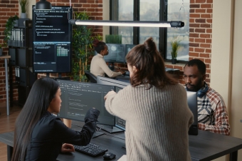 Imagem de quatro pessoas com computadores